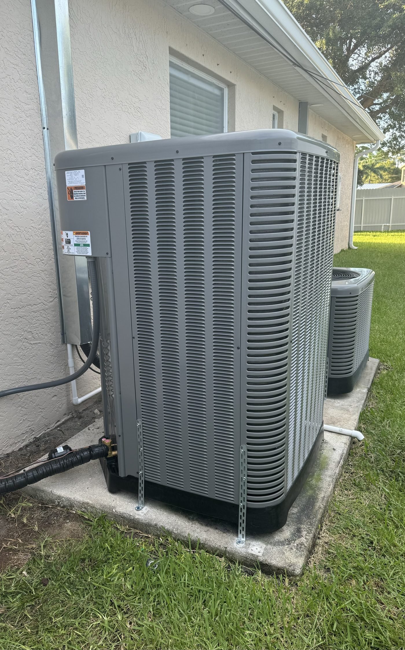 Dual outdoor condenser units on concrete pad residential